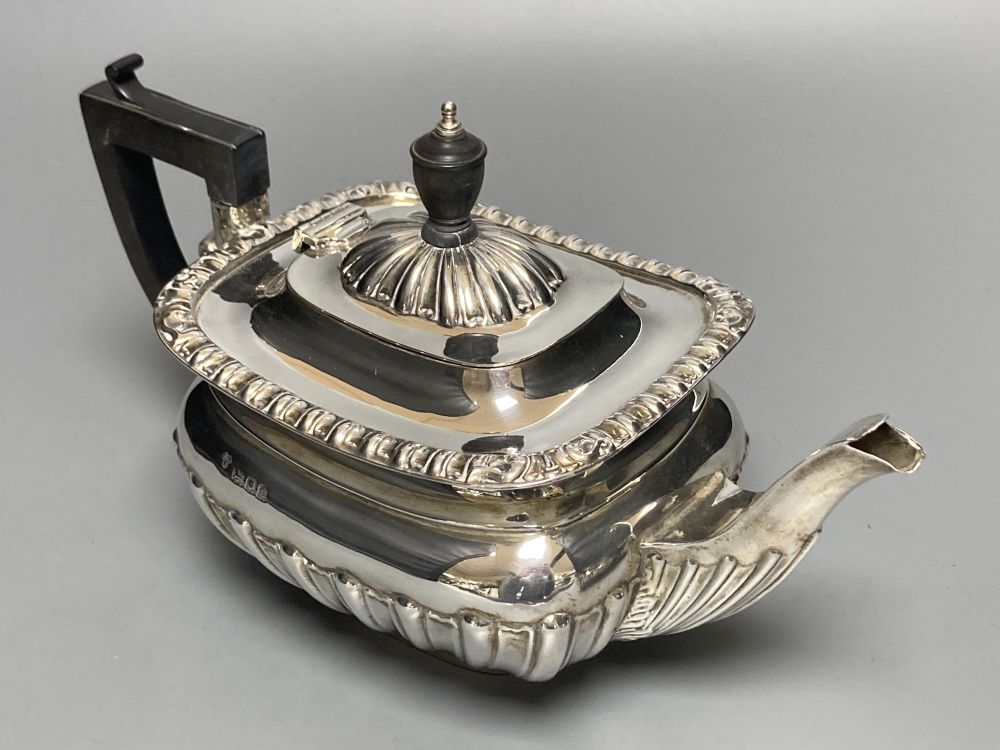 A George V demi fluted silver four piece tea set by Charles Boyton & Son Ltd, London 1918 and 1922,